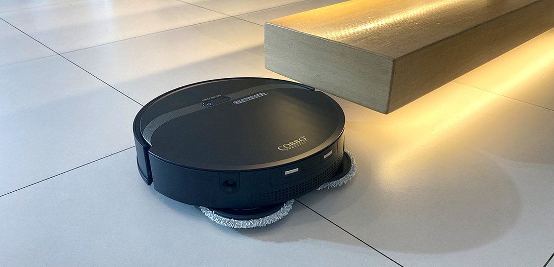 czarny robot sprzątający na jasnych płytkach